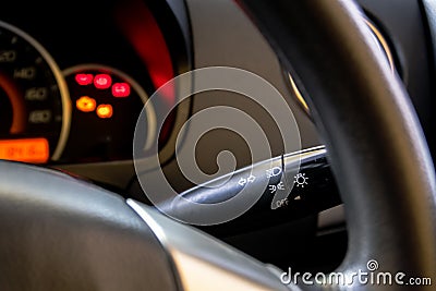 Light lever and steering wheels of modern car dashboard with blurry and soft focus instrument background Stock Photo