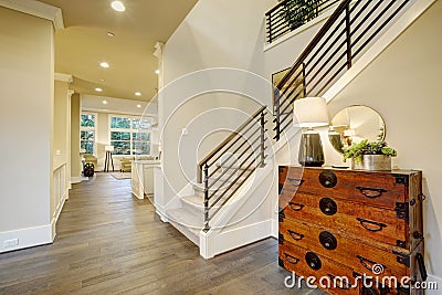 Light modern hallway design boasts steamer trunk dresser Stock Photo