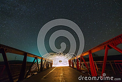 Light painting art concept. Long exposure shot of spinning steel wool in abstract circle making firework showers of bright yellow Stock Photo