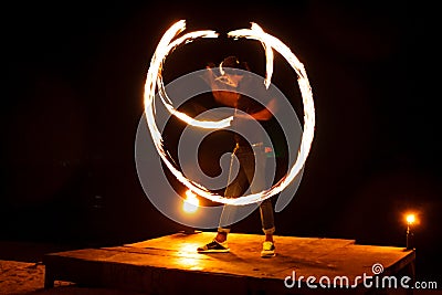 Light painting and long exposure picture of a street artist fire juggling performance. Phi Phi Island, Thailand. Stock Photo