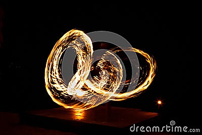 Street artist fire juggling performance. Light painting and long exposure picture to form trails. Phi Phi Island, Thailand. Stock Photo