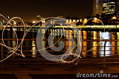 Light painting at night by the river in Puerto Madero Stock Photo