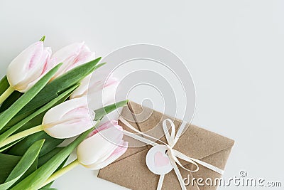 Light pink tulips and envelope isolated on white with copy space Stock Photo