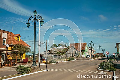 Light poles and houses in avenue of Cambara do Sul Editorial Stock Photo