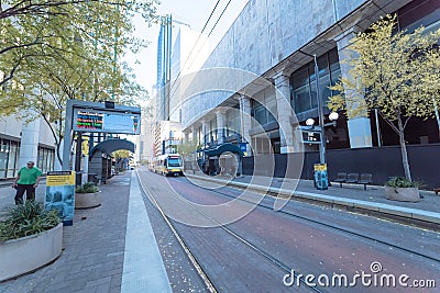 Light rail train station with passenger waiting in downtown Dall Editorial Stock Photo
