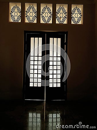 Light and reflection on floor through glass door and clerestory Stock Photo