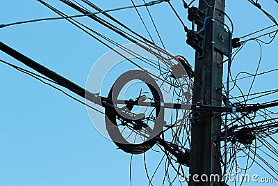 Light and shadow electric poles and electric wires located high on the sky background, selectable focus. Stock Photo