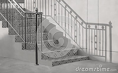 Light and shadow on surface of vintage stainless steel handrail with outside staircase in entranceway of home, black and white Stock Photo