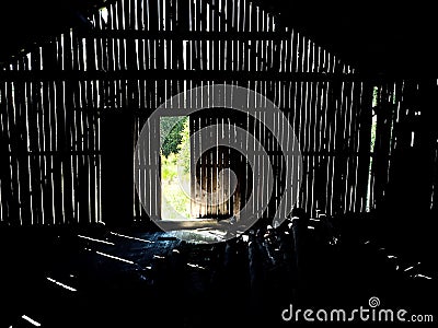 Light shining through gaps in the wall of an old barn Stock Photo