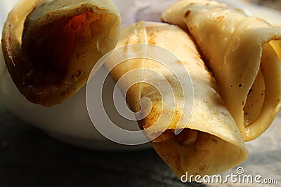 Light snack and tasty popular fast food `Egg Roll` close and cropped view. Stock Photo