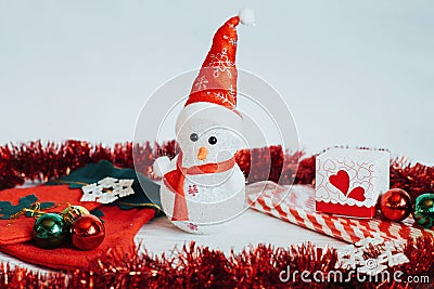 Light snowman doll and Christmas decorations on a white wooden b Stock Photo