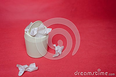 Light trash bin on red background. Closeup of crumpled sheets of paper. Concept of environmental recycling paper waste Stock Photo