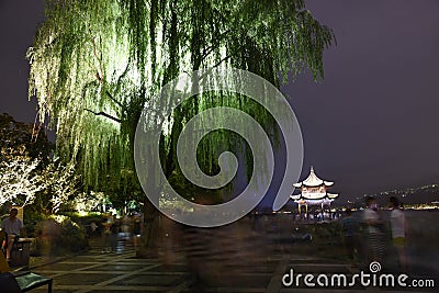 A light up Weeping Willow tree and pagoda over Westlake Editorial Stock Photo