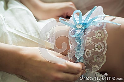 Wedding garter on the bride`s leg Stock Photo