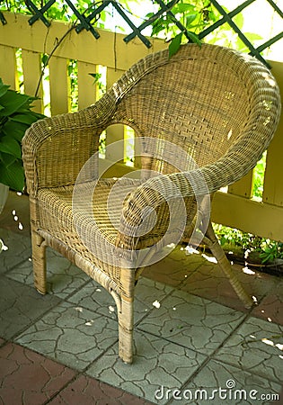 Light wicker rattan chair in the garden gazebo Stock Photo