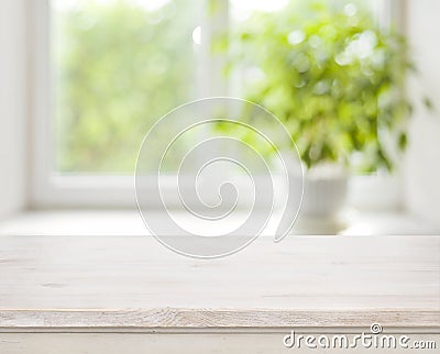 Light wooden table on defocuced spring window background Stock Photo