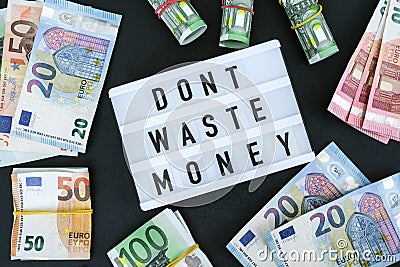 Lightbox board with word DONT WASTE MONEY in black letters around euro banknotes. Money, Business, finance, investment, saving Stock Photo