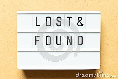 Light box with word lost & found on wood background Stock Photo
