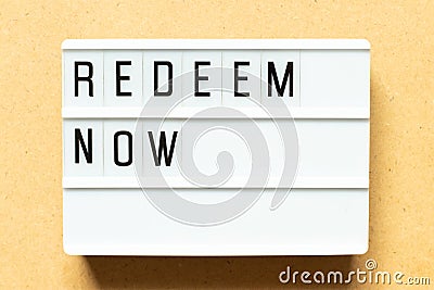 Light box with word redeem now on wood background Stock Photo