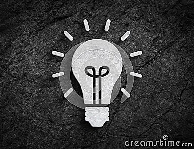 Lightbulb symbol stone wall background Stock Photo