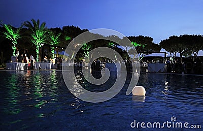 Lighted Candles on Pool, Dinner Party, Dusk Scene Stock Photo