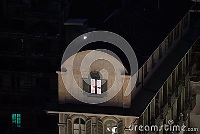 Lighted window of a top floor flat Stock Photo