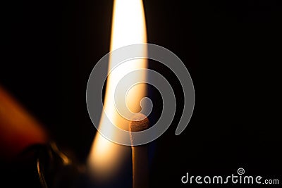 Lighter flame getting close to fire o matchstick Stock Photo