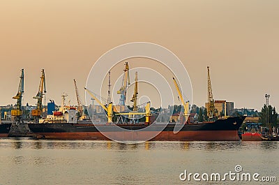 A lighthouse against the sunset sky. Beautiful peaceful seascape. Small ships on the sea horizon Editorial Stock Photo