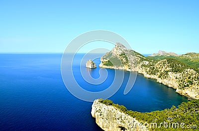 Lighthouse on an island in the blue sea Stock Photo