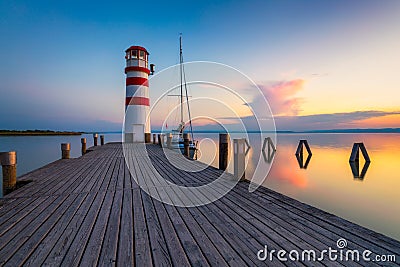 Lighthouse at Lake Neusiedl, Podersdorf am See, Burgenland, Austria. Lighthouse at sunset in Austria. Wooden pier with lighthouse Stock Photo