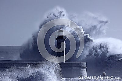 Lighthouse in the middle of stormy waves Stock Photo