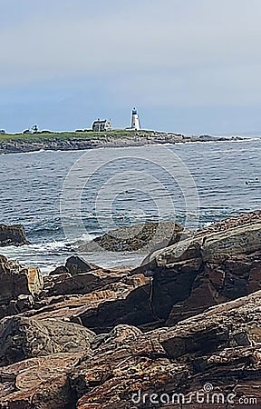 Lighthouse ocean rocks grass sky view Stock Photo