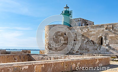 Lighthouse over Castello Maniace Castle fortress at Ionian sea on Ortigia island old town of Syracuse in Sicily in Italy Editorial Stock Photo