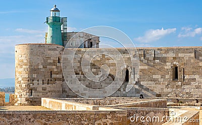 Lighthouse over Castello Maniace Castle fortress at Ionian sea on Ortigia island old town of Syracuse in Sicily in Italy Editorial Stock Photo