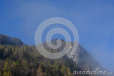 Lighthouse on peak of mountain on foggy morning in Alps, Bad Ragaz Stock Photo