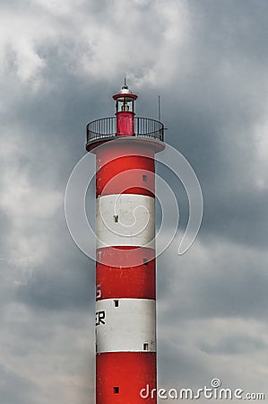 Lighthouse of Port-La-Nouvelle in red and white on cloudy sky Stock Photo