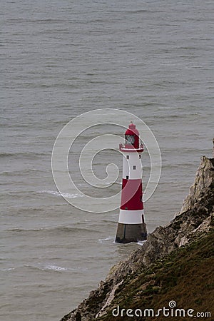 Lighthouse red and white striped on stormy winter day. Stock Photo