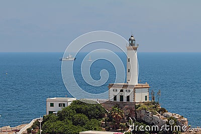 Lighthouse on rocky shore and sea. Ibiza, Spain Stock Photo