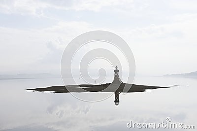 Lighthouse silhouette port harbor harbour island ocean bright light warning protection sea ships boats fisherman port glasgow gree Stock Photo