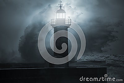 Lighthouse in a stormy night Stock Photo