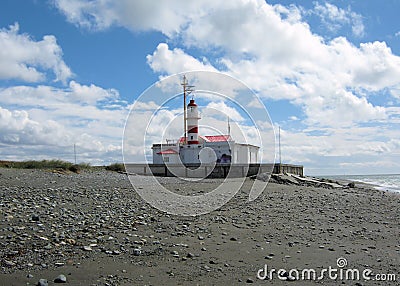 Lighthouse Straits of Magellan with shore, clouds, Punta Delgada, Chile Editorial Stock Photo