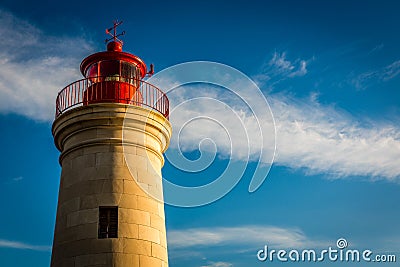 Lighthouse sunset with blue sky and clouds Stock Photo