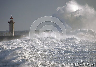 Lighthouse under big waves Stock Photo