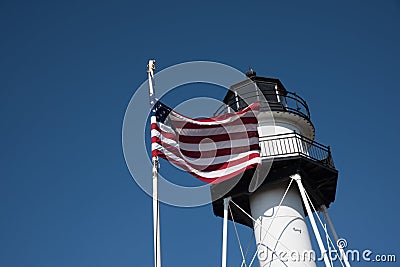 Lighthouse with United States flag in Conney Island - New York. Stock Photo