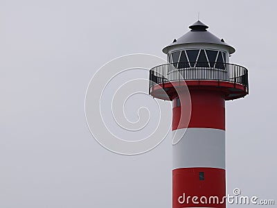 Lighthouse, with windows, roof and railing, red withe strips, many space for text. Stock Photo