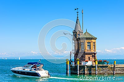 Lighthouse and yacht in harbor of Constance or Konstanz, Germany. Beautiful scenic view of Constance Lake Bodensee in summer Stock Photo