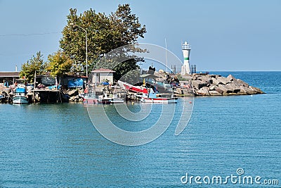 Lighthouses and fishing boats at Akcakoca harbor in Duzce province, Turkey Stock Photo