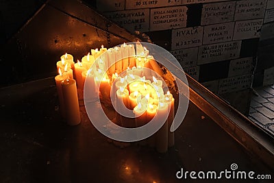 Lighting candles in chapel of Our Lady from the Kamenita vrata Stone Gate in Zagreb to remember and honor the deceased loved Editorial Stock Photo