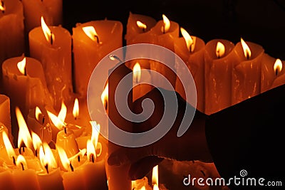 Lighting candles in chapel of Our Lady from the Kamenita vrata Stone Gate in Zagreb to remember and honor the deceased loved Stock Photo