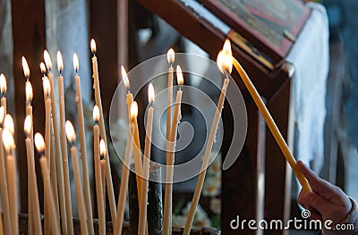 Lighting a Church candle Stock Photo